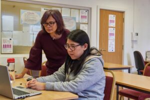 Teacher helping student